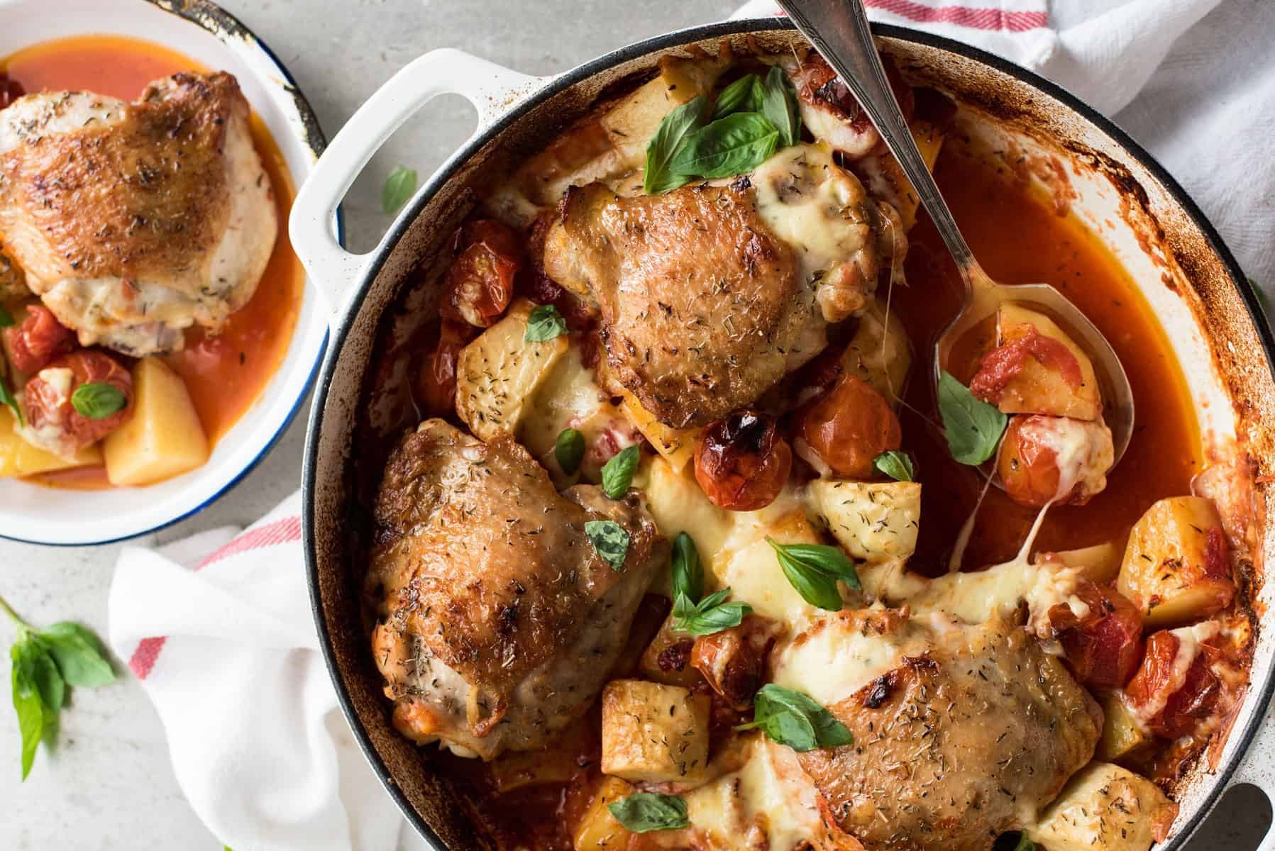 Baked Italian Chicken with Potatoes in a white casserole dish, fresh out of the oven.