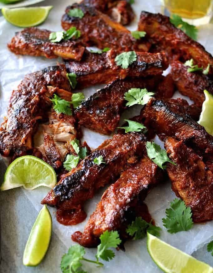 A tray of Oven Baked Ribs with Chipotle Barbecue Sauce scattered with cilantro