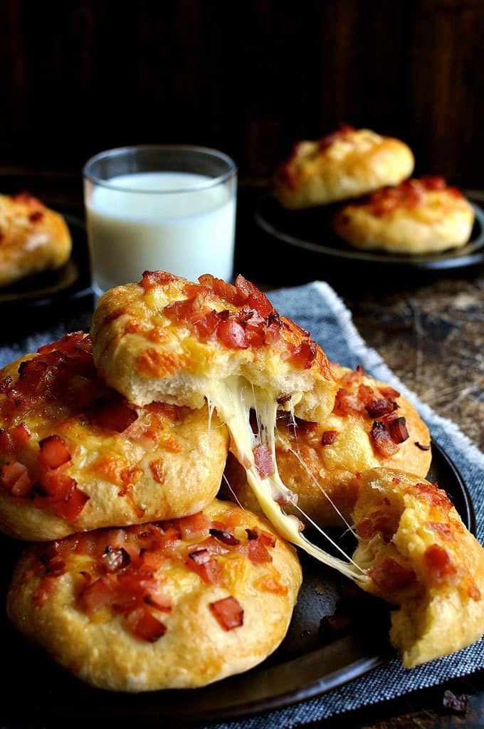 Cheese strings oozing from Double Cheese and Bacon Rolls