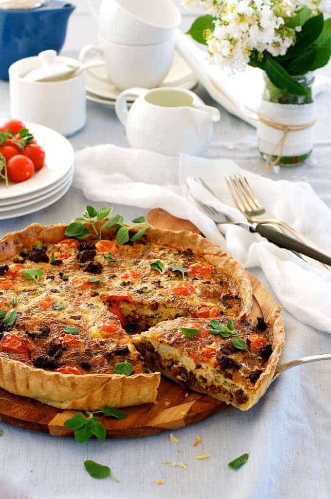 Table setting with whole Italian Sausage Quiche