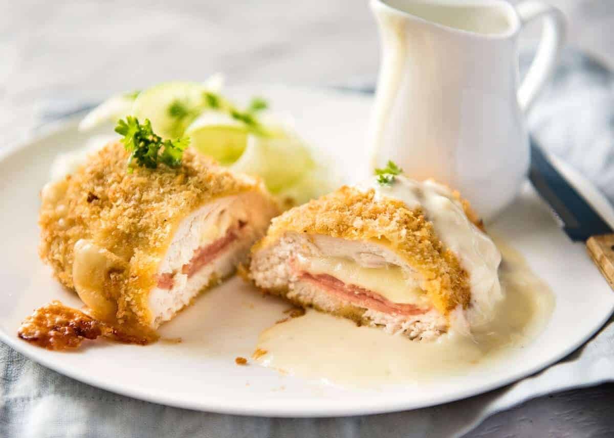Easy Chicken Cordon Bleu - You are going to be amazed how easy it is to make this chicken stuffed with cheese and ham, coated in crunchy breadcrumbs and served with a gorgeous cheese sauce! recipetineats.com