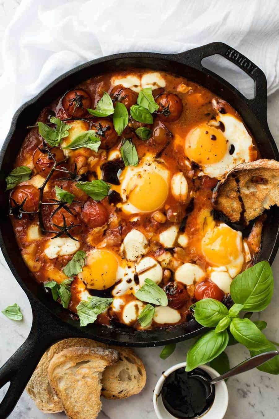 Caprese Baked Eggs drizzled with balsamic vinegar, with toast