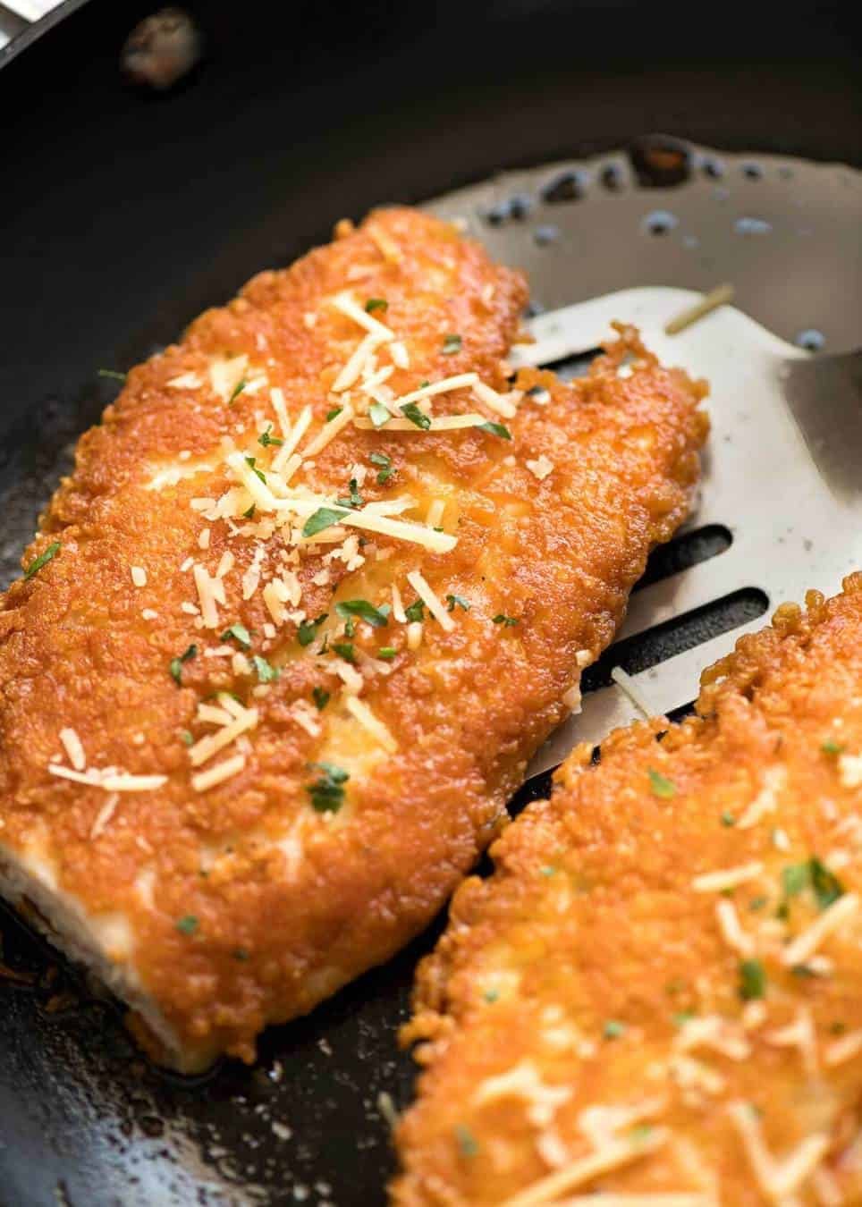 Parmesan Crusted Chicken Breast being cooked in skillet.