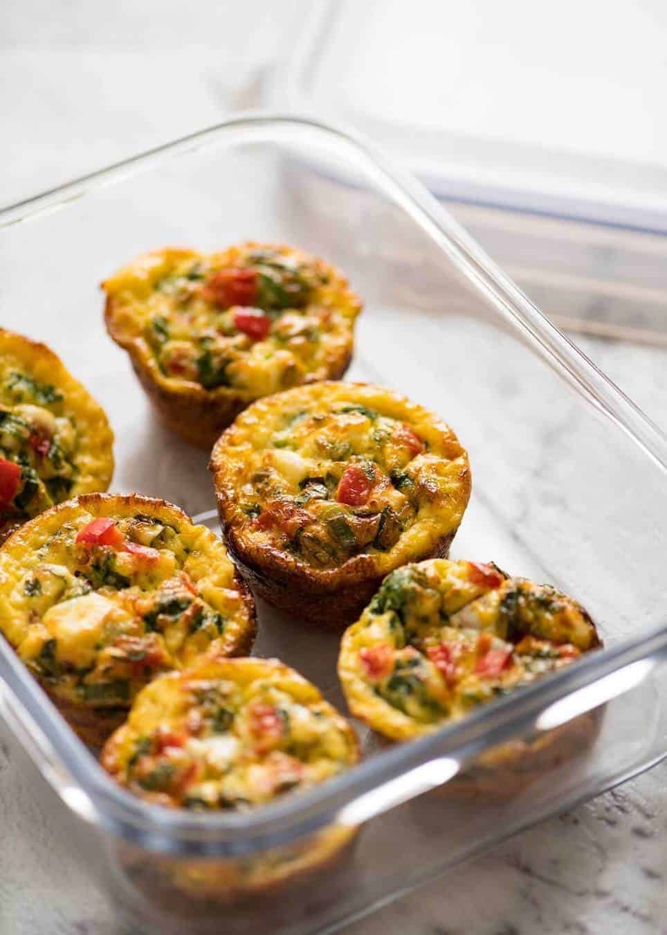 Healthy doesn't have to be bland! These Healthy Egg Muffins are a great grab & go breakfast option. Egg, spinach, feta, cherry tomatoes and bell peppers/capsicum. www.recipetineats.com