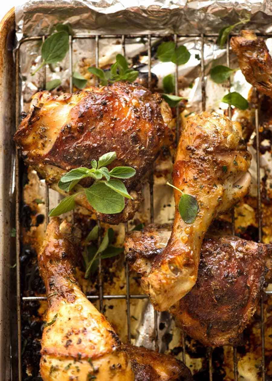 Baked Greek Chicken on a tray, fresh out of the oven