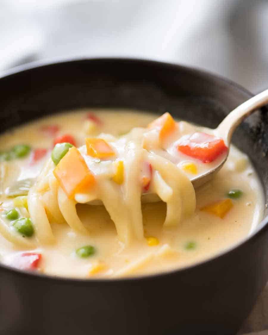 Spoon scooping up Cream of Vegetable Soup with Noodles (no cream!)