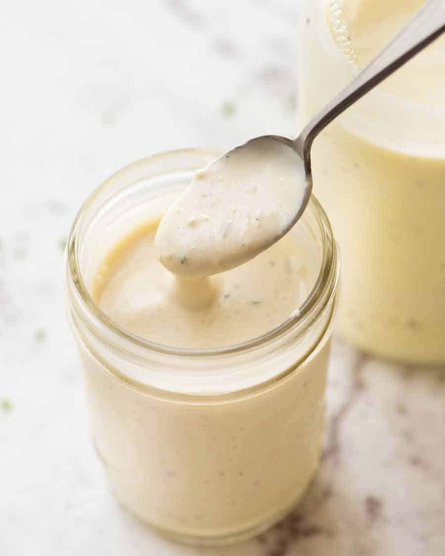 Close up of jar with Healthy Caesar salad Dressing (no mayo yoghurt dressing)