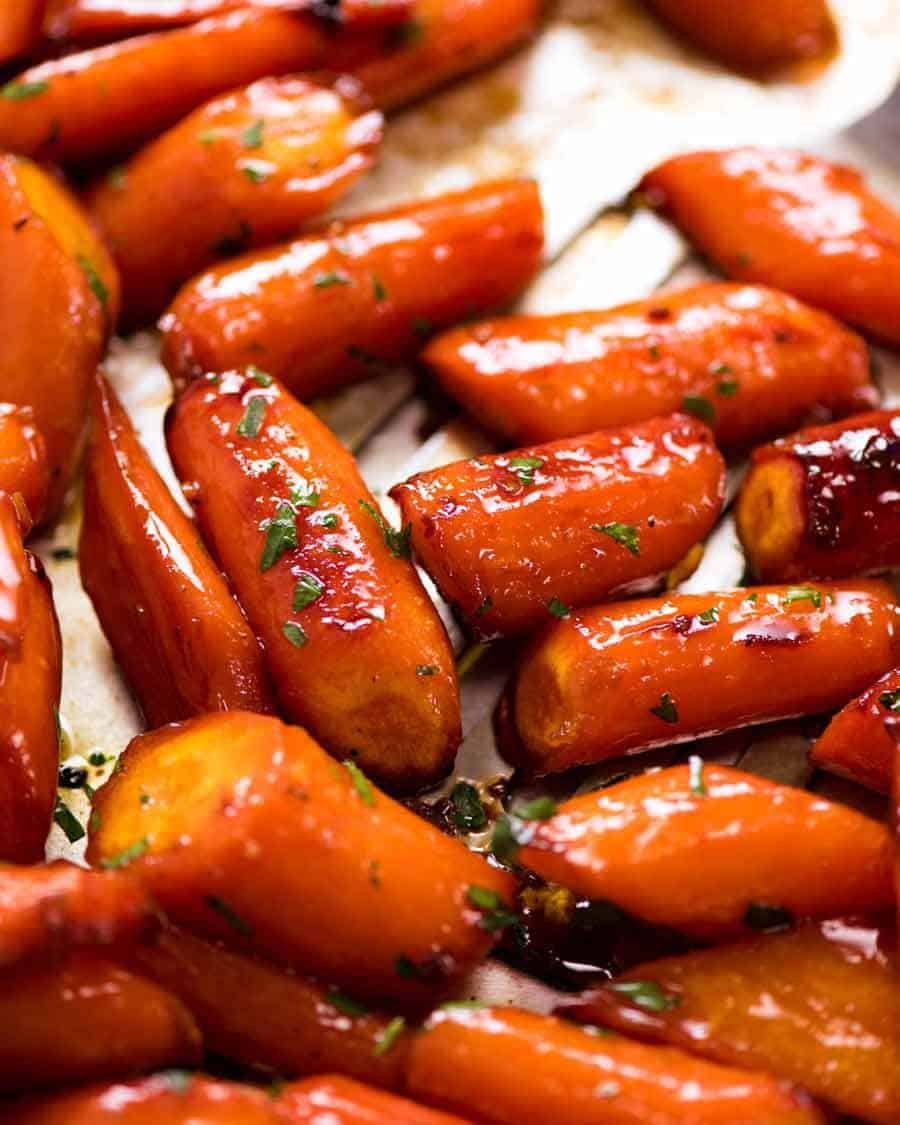 Close up of Brown Sugar Glazed Carrots on a tray, fresh out of the oven