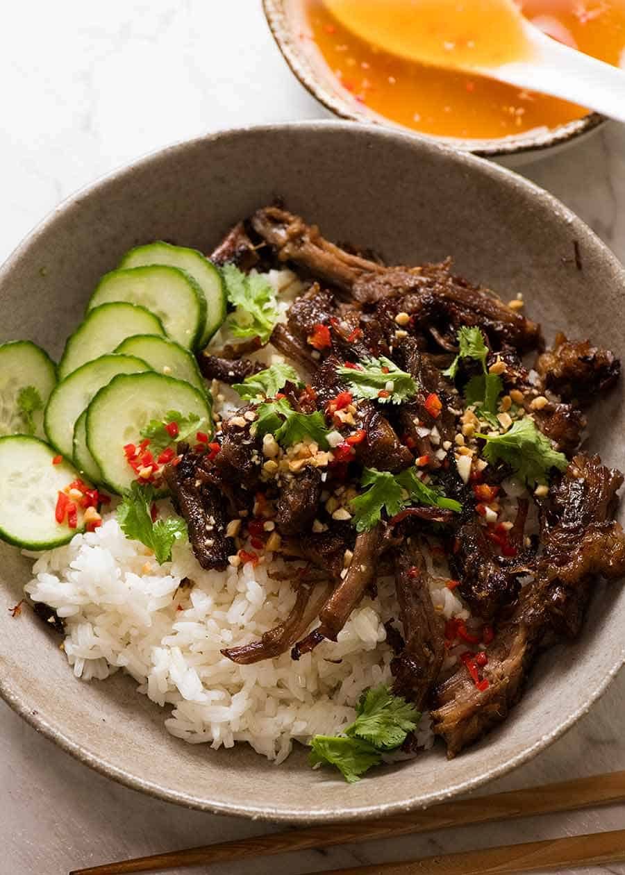 Caramelised Vietnamese Shredded Beef served over rice with lime wedges, cucumber, chilli and peanuts with Nuoc Cham sauce