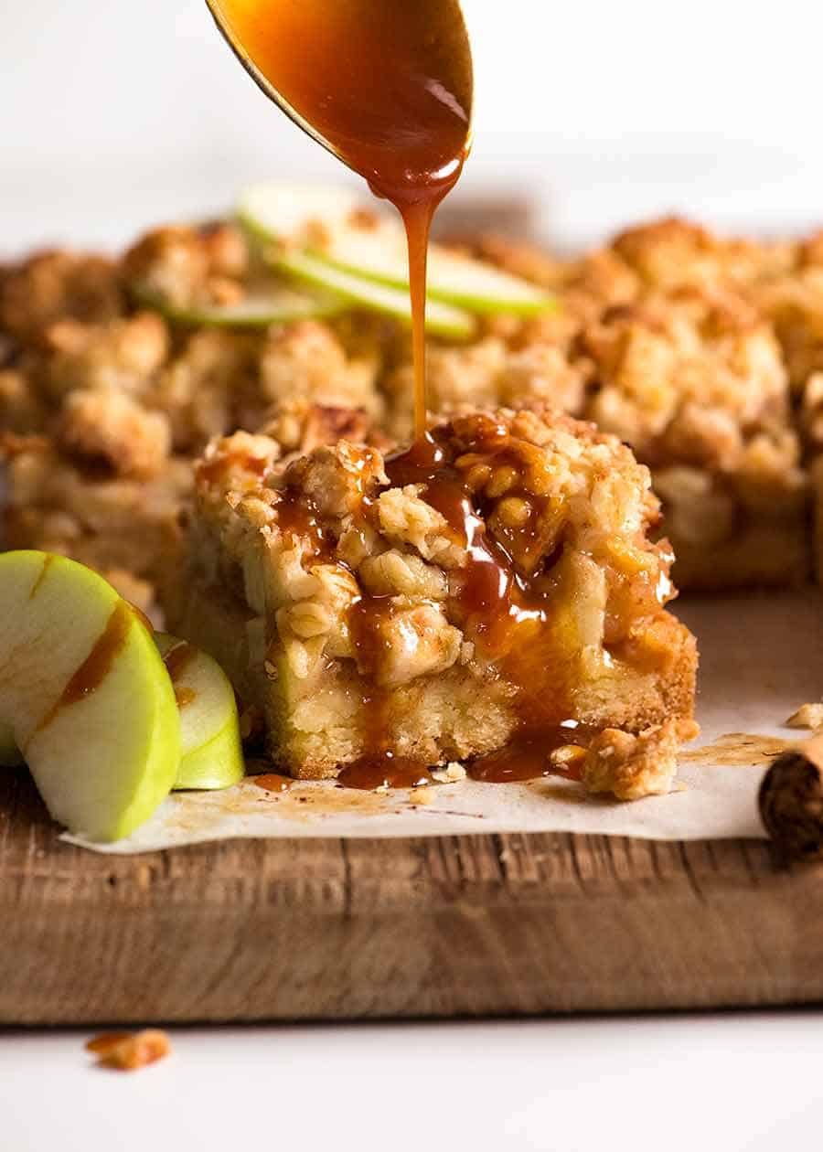 Salted caramel sauce being drizzled over Apple Crumble Bars