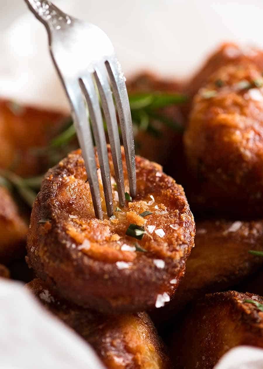 Close up of fork piercing a Duck Fat Roast Potato