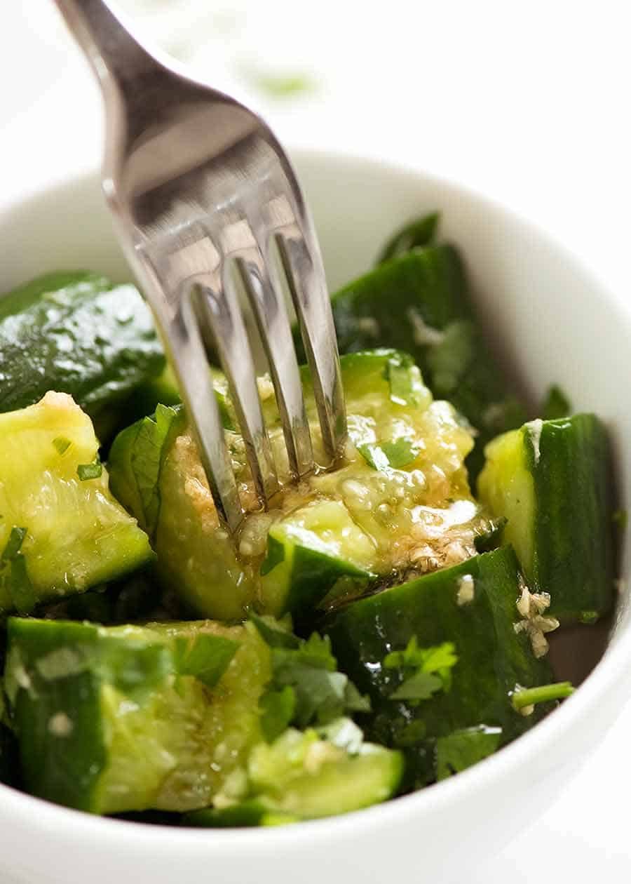 Close up of fork piercing Smashed Cucumbers