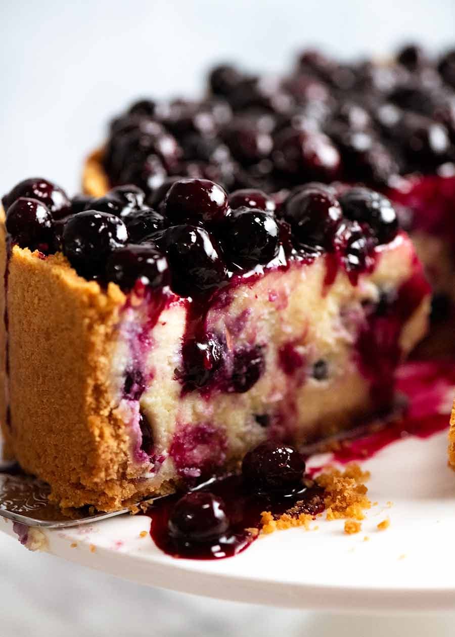 Close up of slice of Blueberry Cheesecake with drip of Blueberry Sauce