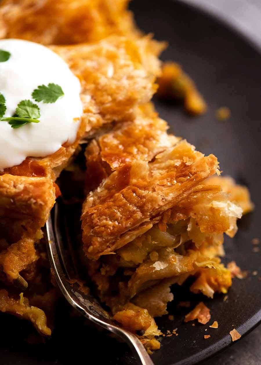 Close up of flaky puff pastry of Vegetable Samosa Pie