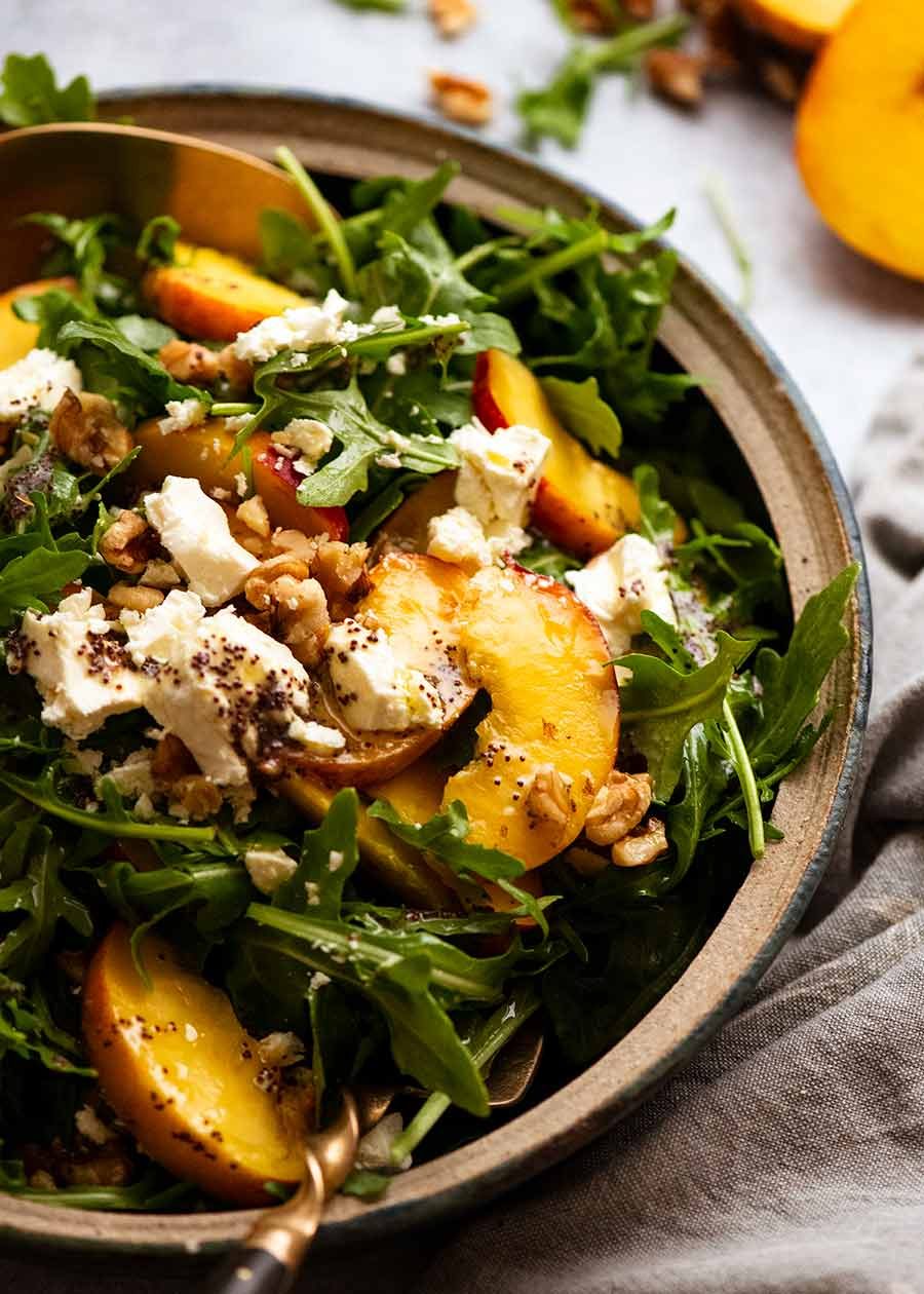 Bowl piled high with Peach Salad with Poppyseed Dressing