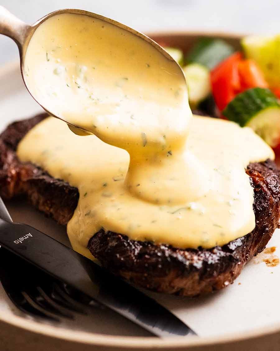 Spooning Bearnaise Sauce over steak