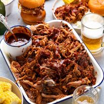 My best pulled pork in a pan with sides ready to be served