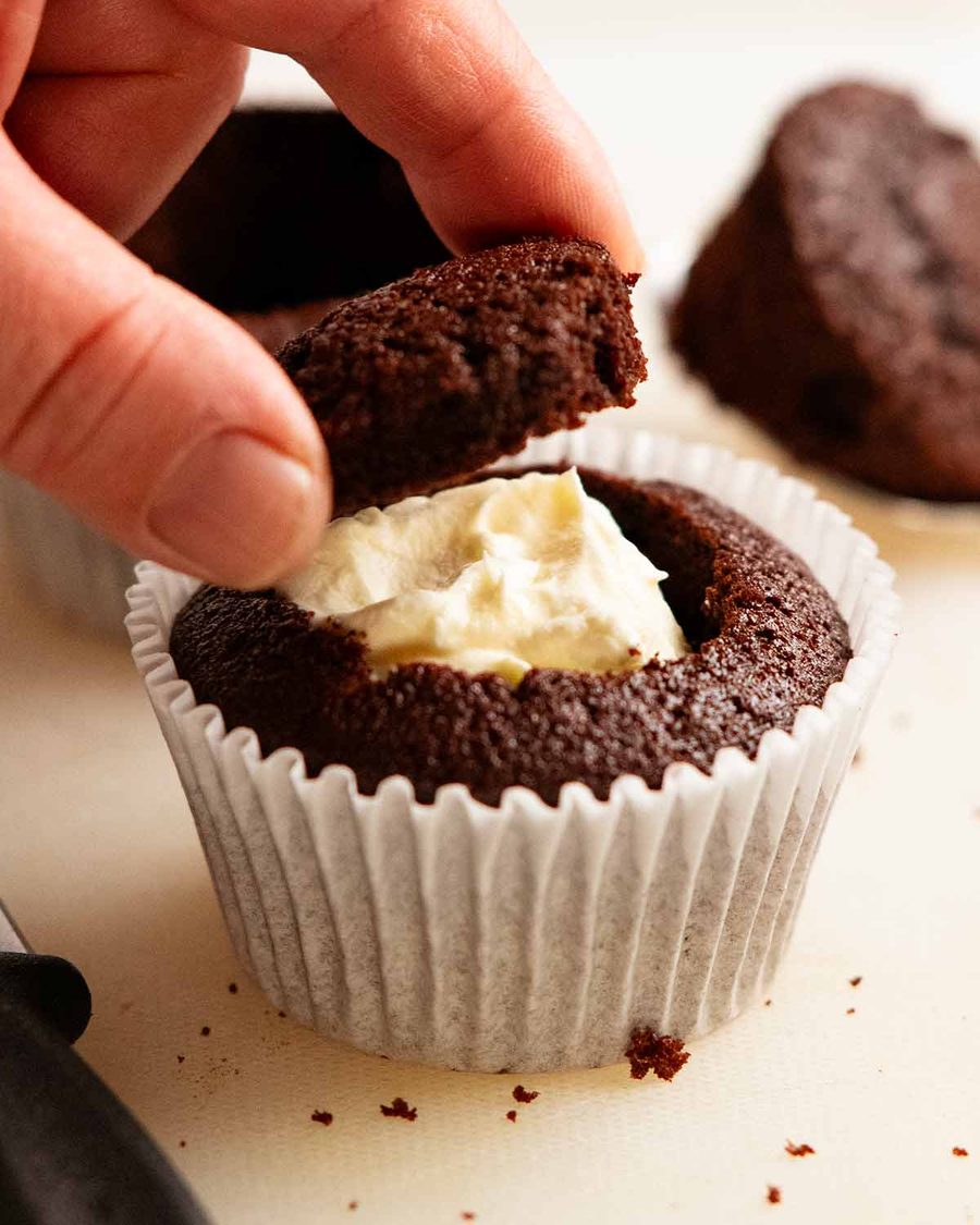 Whipped vanilla cream filled chocolate cupcakes with ganache frosting