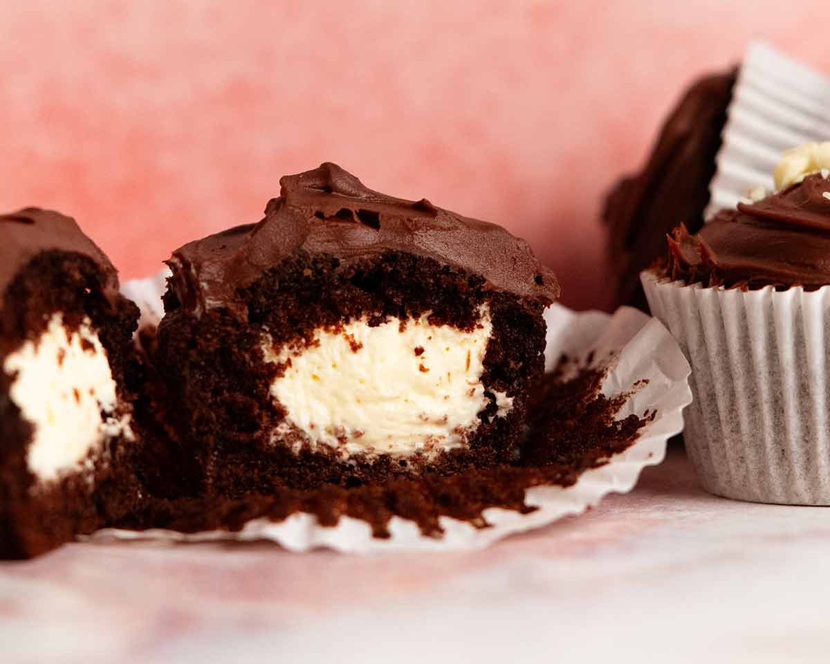 Whipped vanilla cream filled chocolate cupcakes with ganache frosting